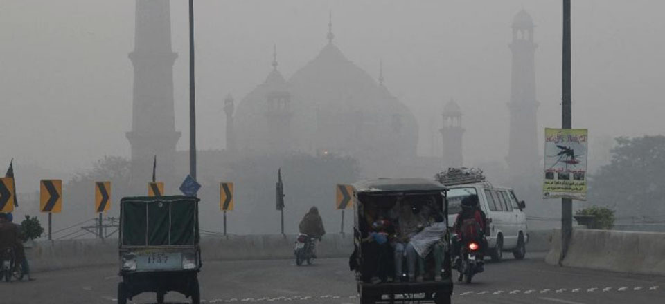 Smog engulfs a road close to Badshahi mosque in Lahore, Pakistan.