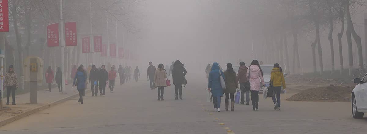 University students walk in dense air pollution, Anyang Normal University, Henan Province, China. Photo: V.T. Polywoda